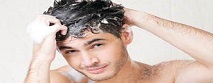 Guy washing hair in shower