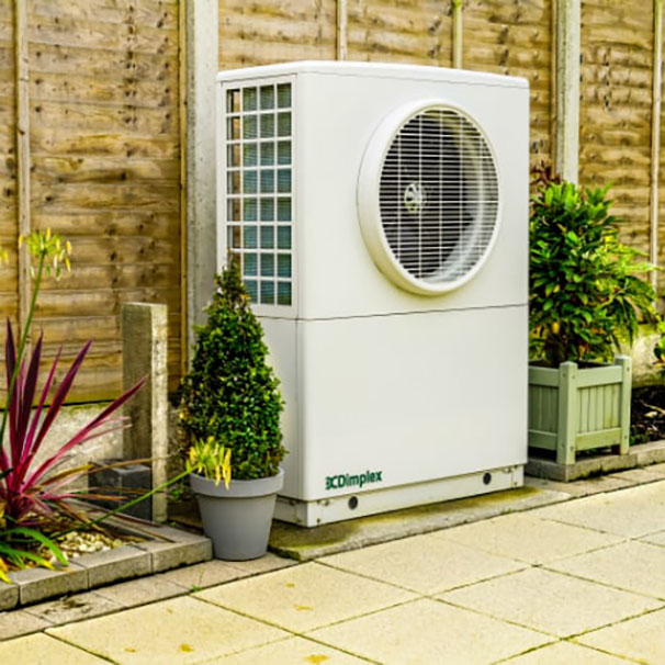 Heat pump unit positioned outside a house for efficient heating and cooling.