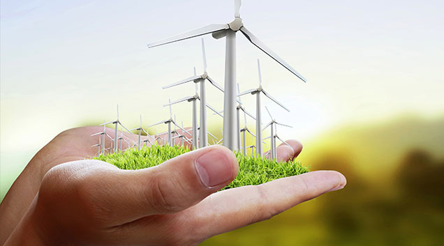 This is an image of wind turbines on green grass depicting green electricity generation