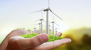 This is an image of wind turbines on green grass depicting renewable energy