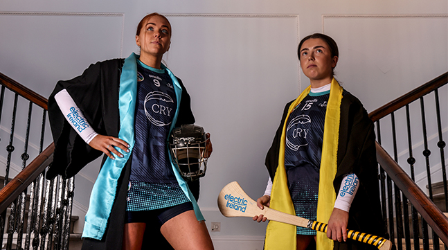 Two young women Camogie players striking a pose.