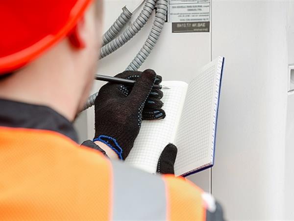 A heat pump technician inspecting heat pump system