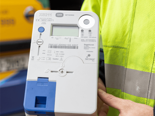 Close-up of hands holding a smart meter.
